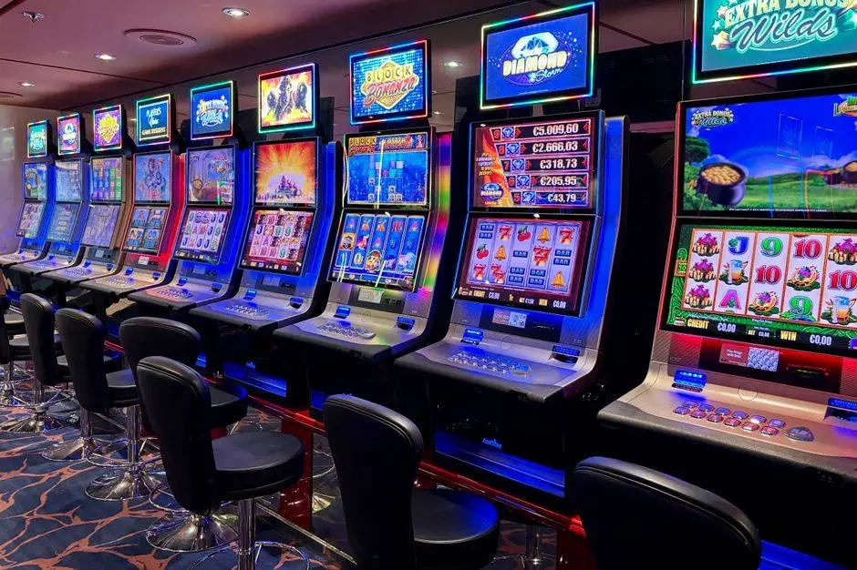 Bright casino slot machines with colorful displays and no people present.